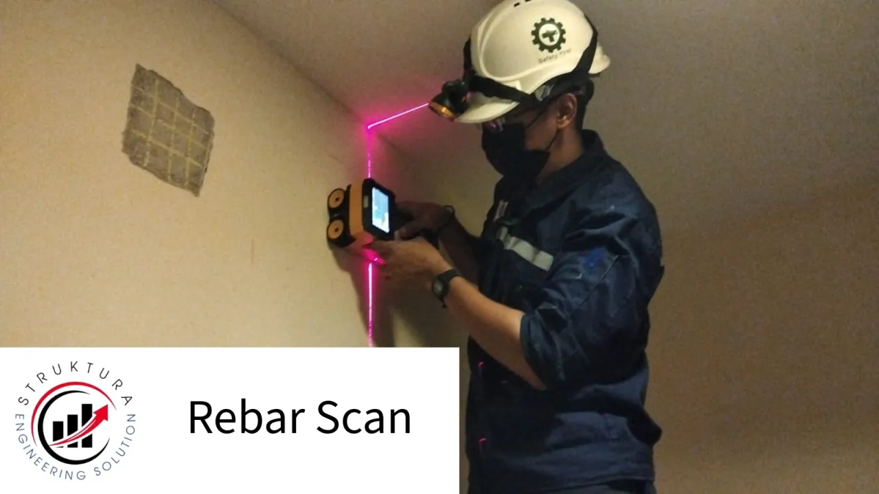 Technician scanning reinforcement in a vertical concrete element using a laser guide