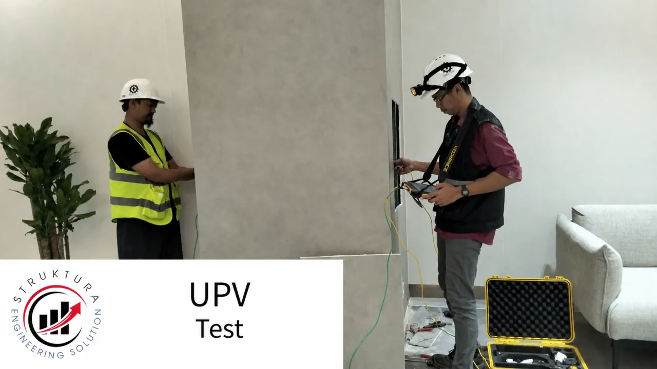 Two technicians positioning UPV transducers on a concrete column