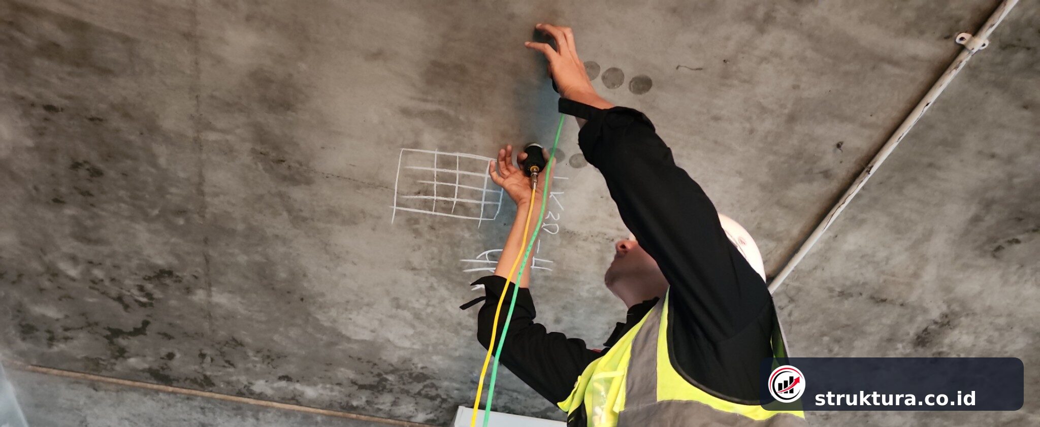 Teknisi menempatkan dua transducer pada grid UPV di permukaan bawah pelat beton